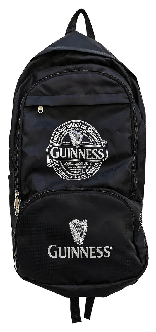 The Guinness Fold Up Backpack, made from durable cotton canvas, showcases the elegant Guinness logo and iconic harp emblem on the front pocket and top section.